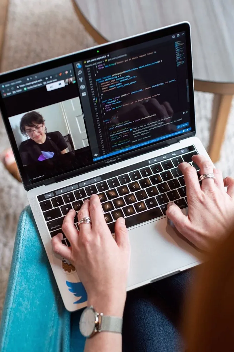 Hands typing on a laptop during a remote working session