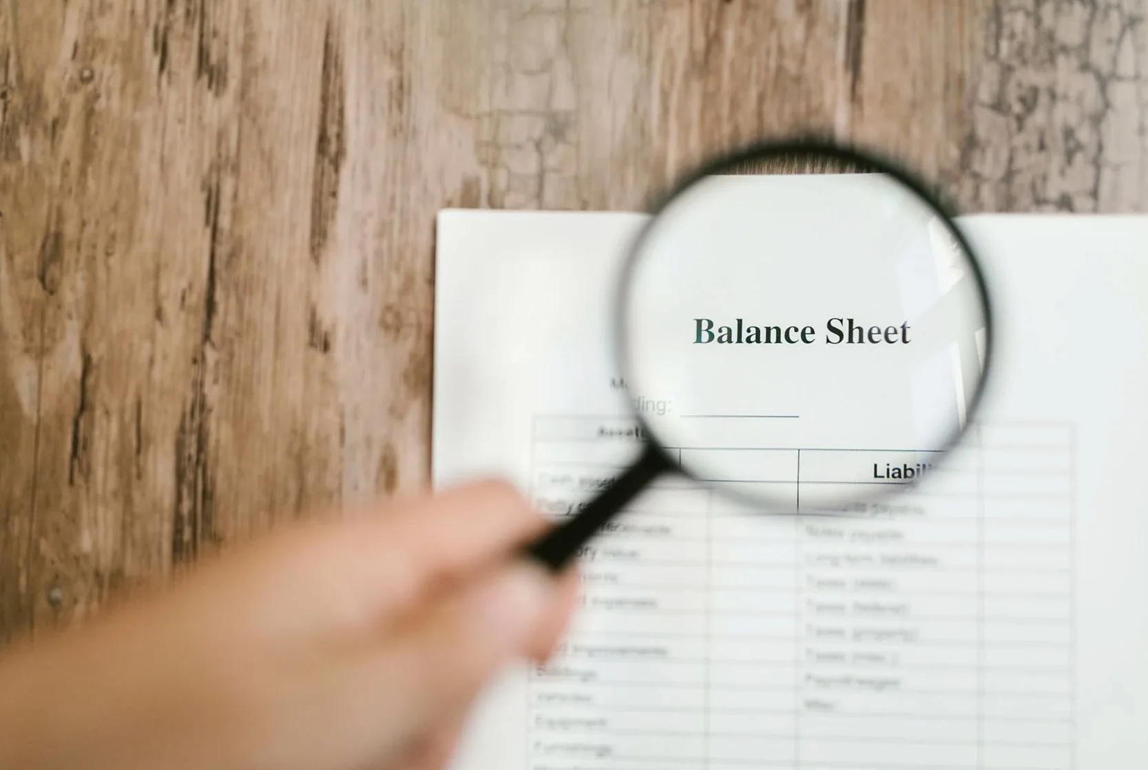 A balance sheet examined through a magnifying glass